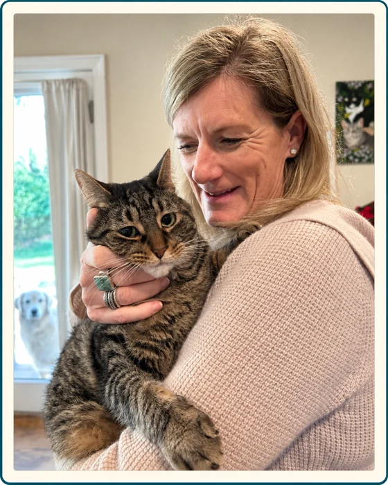 Jeanne cuddling a tabby cat