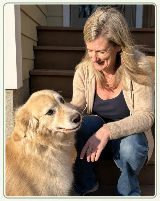 Jeanne sharing a quiet moment with a golden retriever